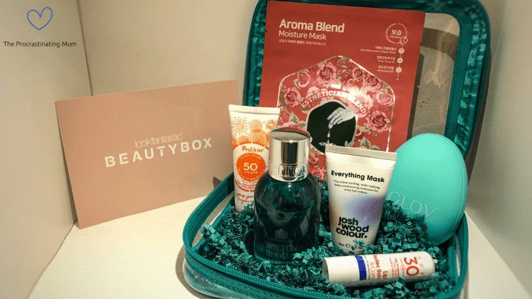 June's lookfantastic Beauty Box items all in the green case sat on shredded green paper